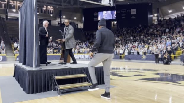 Deion Sanders walks onto the stage at the 2023 Sportsperson of the Year event.